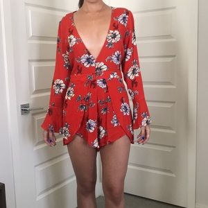 Misguided red romper with plunging neckline